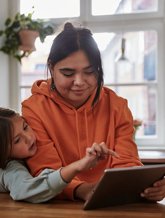 Two people picking out gifts on a tablet together.