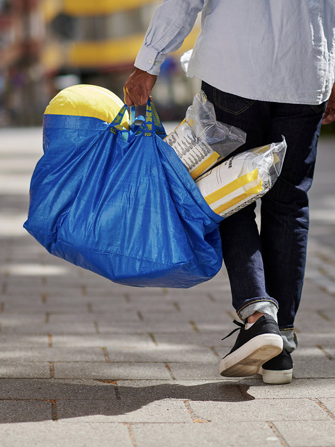 Customer carrying their IKEA purchases.