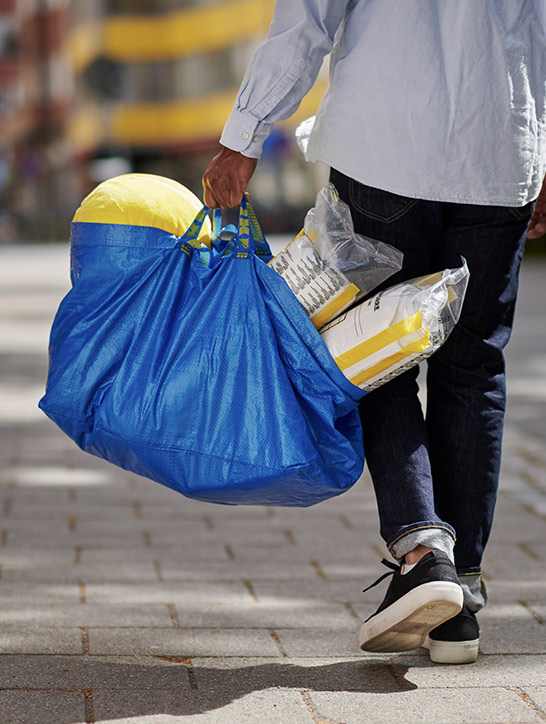 Customer carrying their IKEA purchases.