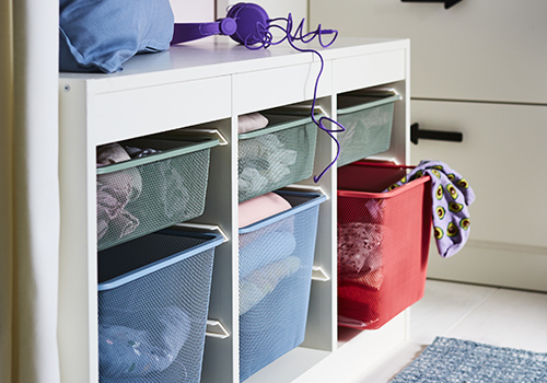 Mesh storage containers in bench.